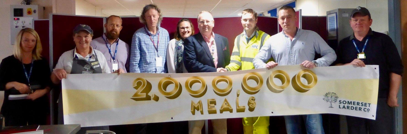 People Holding Banner 200,000 Meals