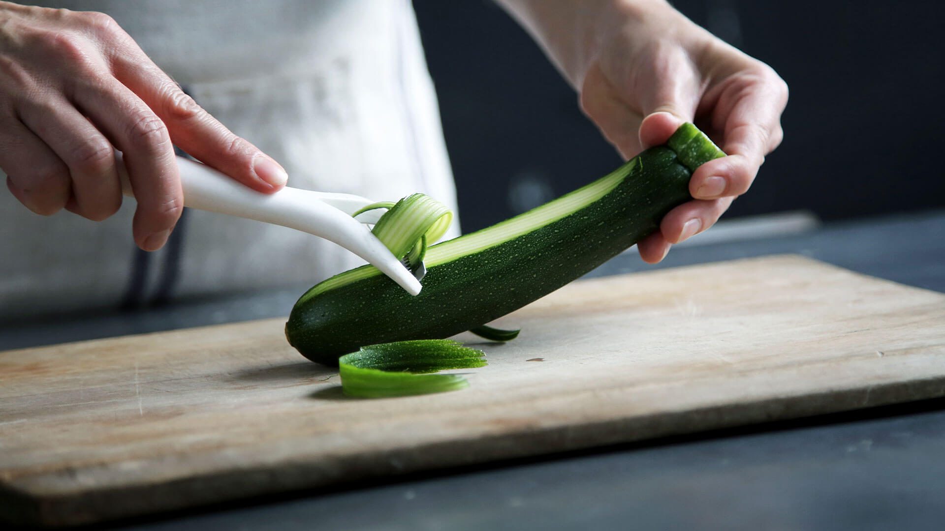 Chef peeling courgette